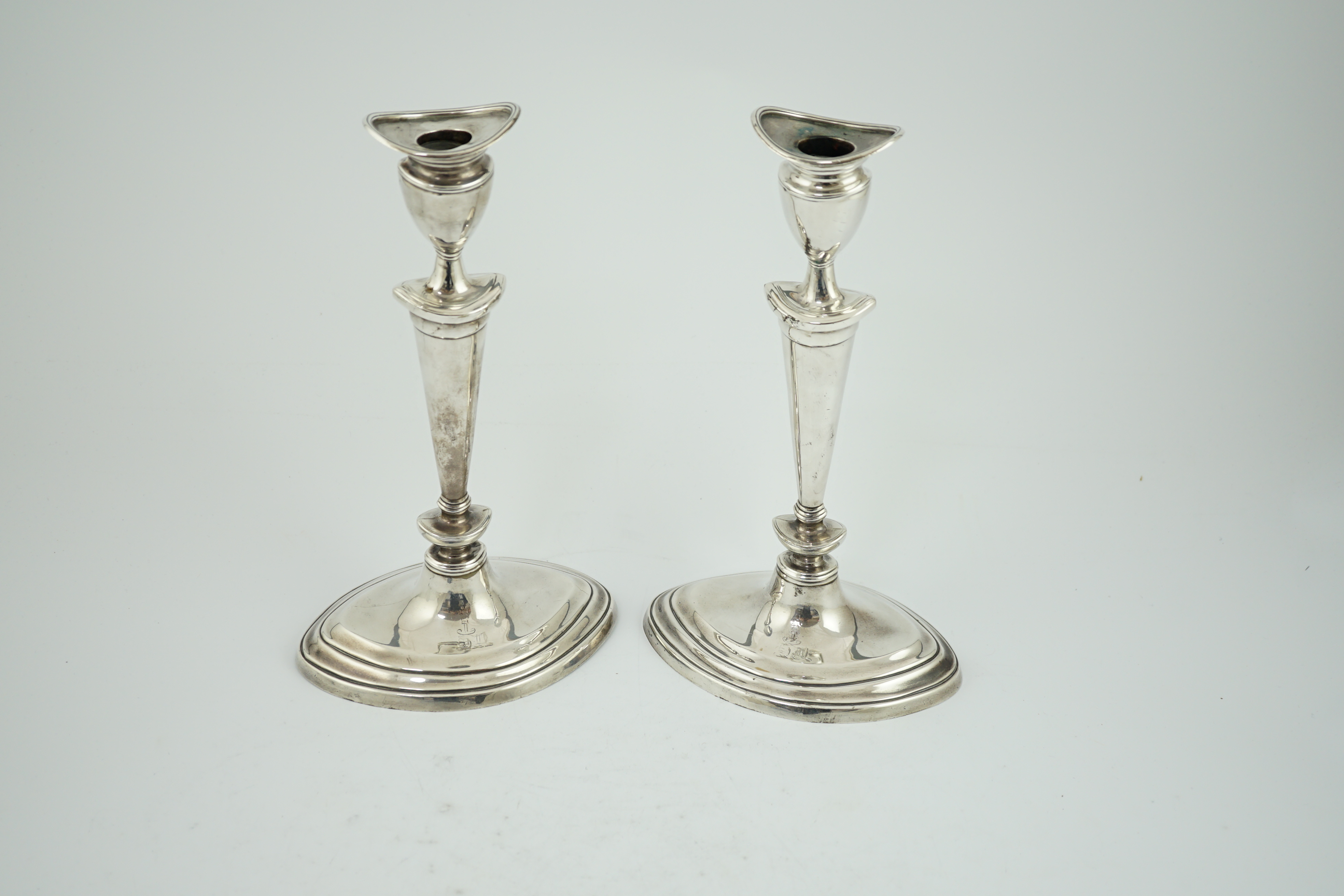 A pair of late Victorian silver oval candlesticks by Goldsmiths & Silversmiths (Gibson & Langman)